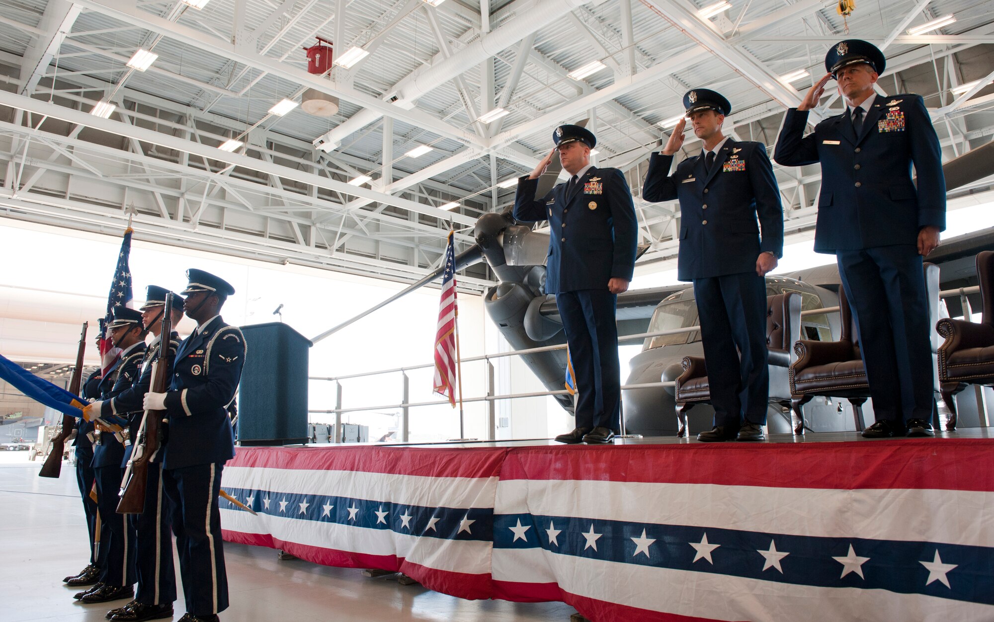 Airmen salute the flag as honor guardsmen present the colors during the 8th Special Operations Squadron change of command ceremony at the Freedom Hangar on Hurlburt Field, Fla. June 14, 2013. (U.S. Air Force photo by Senior Airman Krystal M. Garrett)
