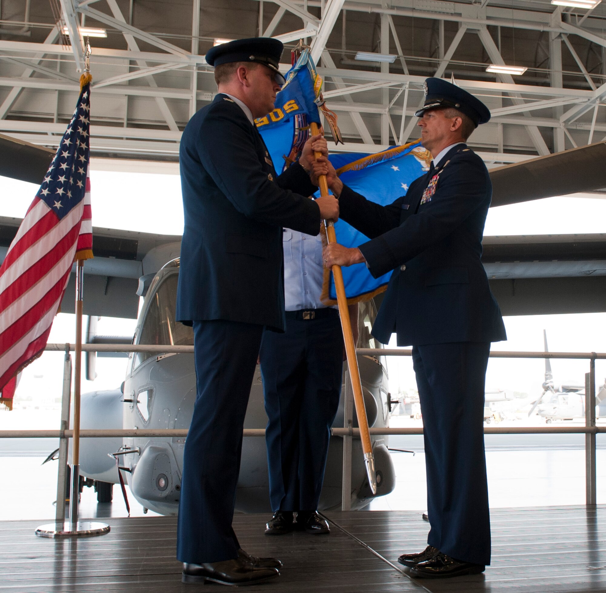 Lieutenant Col. Travis Hill, right, takes the 8th Special Operations Squadron guidon during the 8th SOS change of command ceremony at the Freedom Hangar on Hurlburt Field, Fla. June 14, 2013. This gesture is accomplished in front of the unit so all can witness their new leader assuming command. (U.S. Air Force photo by Senior Airman Krystal M. Garrett)  