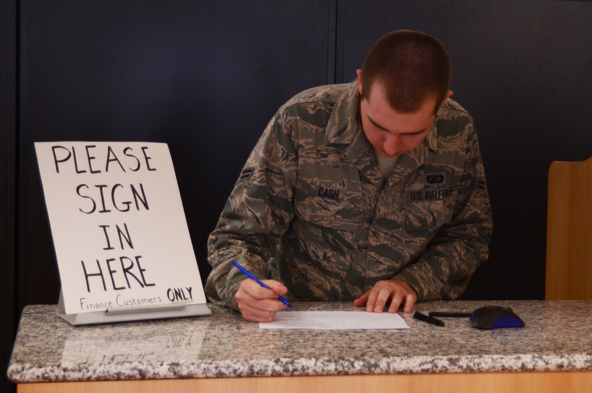 Airman 1st Class Joshua Cash, 86th Comptroller Squadron military pay technician, checks off a customer from the sign-in sheet at the financial services office customer service counter June 11, 2013, Ramstein Air Base, Germany. The FSO customer service counter is open Monday through Friday, 9 to 11 a.m., to  help Airmen with temporary lodging allowance, advance pay, advance housing allowance, advance dislocation allowance, myPay pin resets and payments at the cashier's cage for debts and advances. (U.S. Air Force photo / 1st Lt. Kay M. Nissen)
