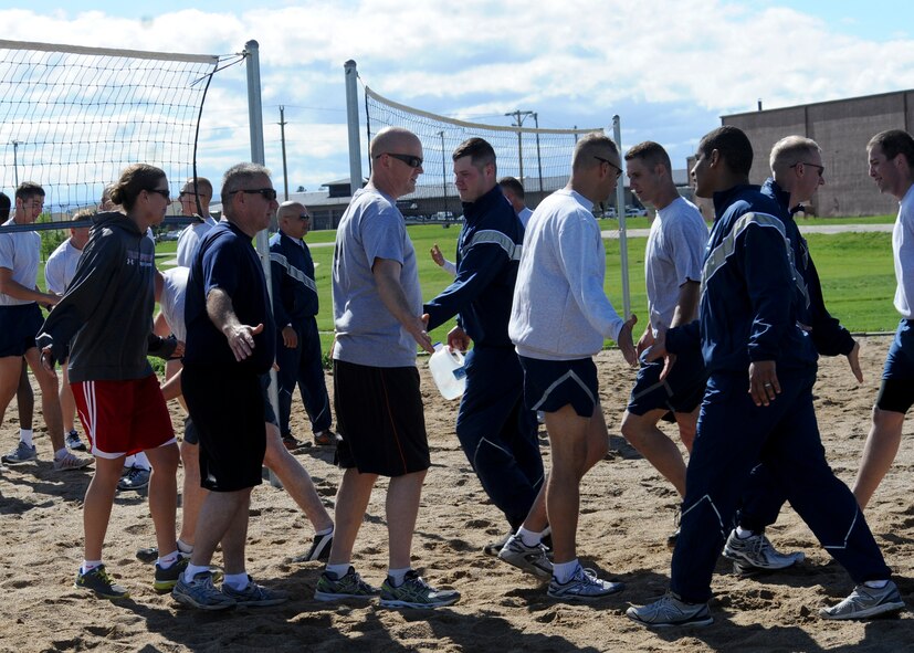 Airman Leadership School class 13-6 students display sportsmanship with Ellsworth senior leaders following a volleyball competition at Ellsworth Air Force Base, S.D., June 4, 2013. The match allowed Airmen to work on fitness, group cooperation skills and morale building, all integral parts of the ALS curriculum. (U.S. Air Force photo by Airman 1st Class Anania Tekurio/Released)