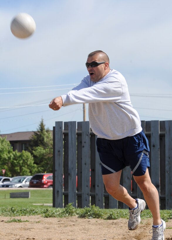 Lt. Col. David Burnett, 28th Force Support Squadron commander, returns a serve during an Airman Leadership School volleyball match at Ellsworth Air Force Base, S.D., June 4, 2013. ALS students competed against commanders, chiefs and first sergeants in the best of a three game set as part of the activity designed to promote healthy competition and wingman camaraderie. (U.S. Air Force photo by Airman 1st Class Anania Tekurio/Released).