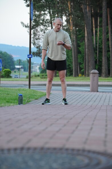 Tech. Sgt. Joshua Morrissette, Battlefield Airman Prospect Training team leader, checks his watch before beginning another set of strength training exercises during a workout session, June 7, 2013, Ramstein Air Base, Germany. The BAPT program’s main focus is to assist Airmen who want to cross train into special operations jobs and pass the physical ability and stamina test. (U.S. Air Force photo/Airman 1st Class Hailey Haux)