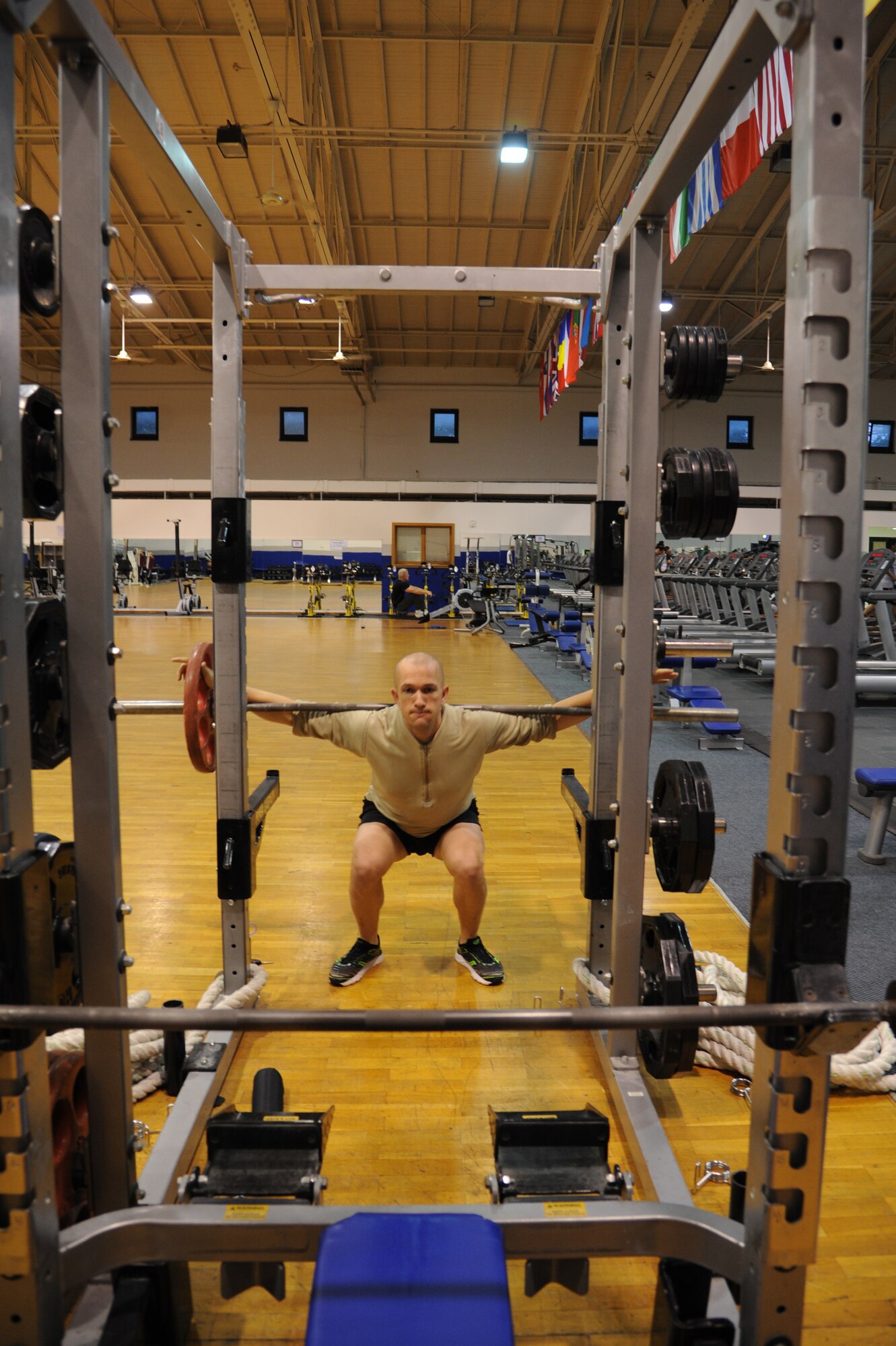 Tech. Sgt. Joshua Morrissette, Battlefield Airman Prospect Training team leader, completes a set of squats during a workout session, June 7, 2013, Ramstein Air Base, Germany. The BAPT program’s main focus is to assist Airmen who want to cross train into special operations jobs and pass the physical ability and stamina test. (U.S. Air Force photo/Airman 1st Class Hailey Haux)