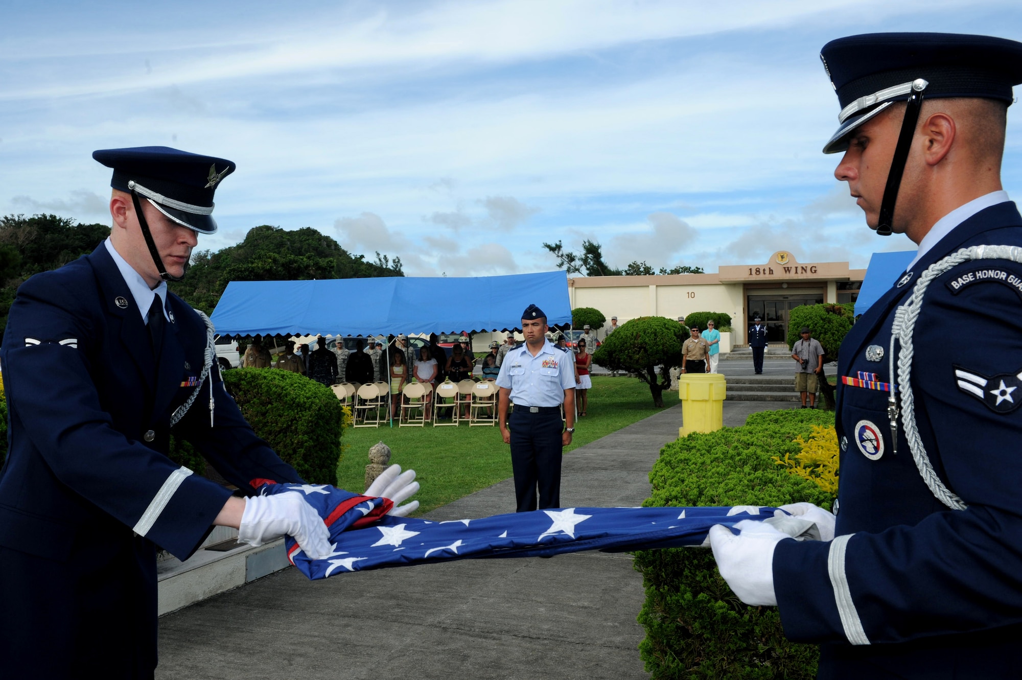 Kadena Honor Guard members fold the American flag during the Flag Day ceremony on Kadena Air Base, Japan, June 14, 2013. The flag was decommissioned by the honor guard and represents all the flags collected, which were retired from service recently. Recently retired flags were taken to an alternate location after the ceremony and burned by 18th Civil Engineer Squadron fire protection personnel. (U.S. Air Force photo by Airman 1st Class Hailey R. Davis/Released)