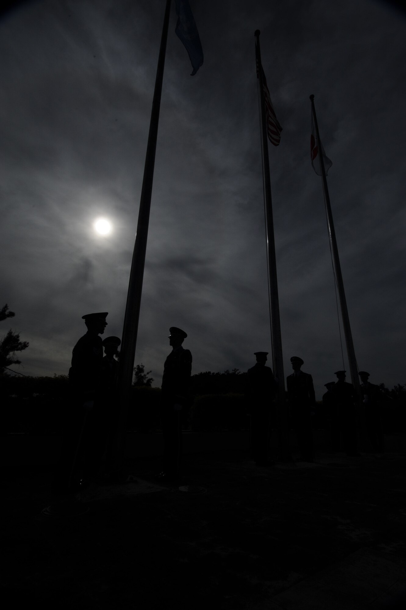 Kadena Honor Guard members prepare to retrieve the flags at the Flag Day ceremony on Kadena Air Base, Japan, June 14, 2013. The ceremony concluded with members of the Civil Air Patrol and the Girl Scouts and Boy Scouts placing unserviceable flags into a barrel, which were then taken to a safe area to be burned by 18th Civil Engineer Squadron fire protection services personnel. (U.S. Air Force photo by Airman 1st Class Hailey R. Davis/Released)