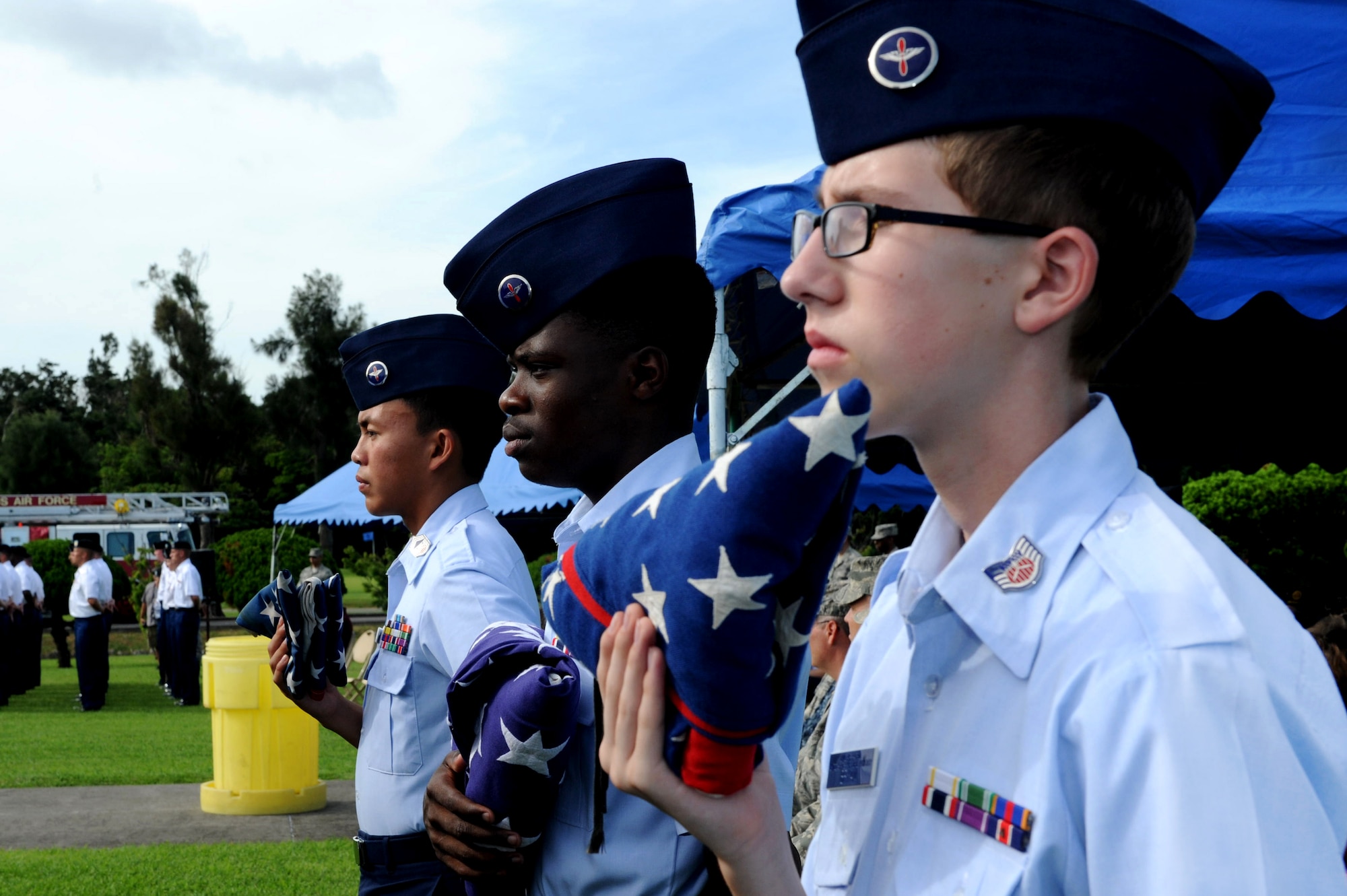 Civil Air Patrol members hold folded American flags during the Flag Day ceremony on Kadena Air Base, Japan, June 14, 2013. Displaying the flag and giving it a distinctive fold shows respect and expresses gratitude toward those who have fought and continue to fight for freedom, at home and abroad. (U.S. Air Force photo by Airman 1st Class Hailey R. Davis/Released)