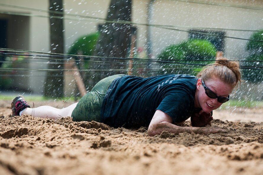 Staff Sgt. Jessica Lafo, 8th Civil Engineer Squadron explosive ordnance disposal technician, low crawls through the mud at Kunsan Air Base, Republic of Korea, June 8, 2013. More than $2,600 was raised for charity during the mud run, which was in honor of 1st Lt. Josh Hovies, who passed in April 2013. Proceeds from the event will be donated to the Special Operations Warrior Foundation in Hovies’ name. (U.S. Air Force photo by Staff Sgt. Jonathan Fowler/Released)
