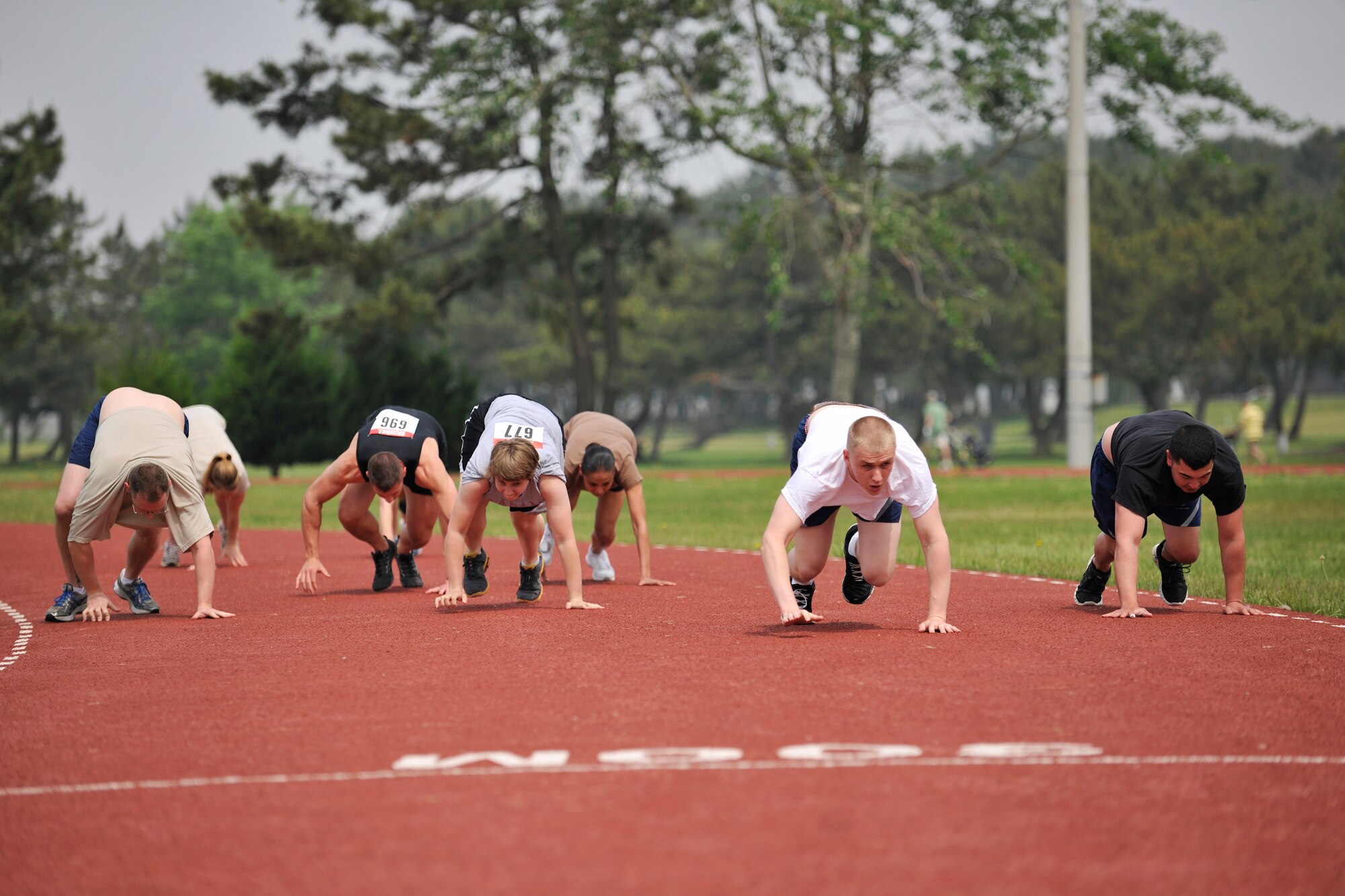 Airmen from the 8th Fighter Wing bear crawl during a section of the Wolf Pack Warrior Mud Run at Kunsan Air Base, Republic of Korea, June 8, 2013. Other obstacles in the course included a sand bag carry, Humvee push, low crawls and a ‘slip and slide’ finish. (U.S. Air Force photo by Senior Airman Clayton Lenhardt/Released)