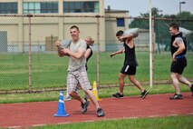 A team  weaves through an obstacle carrying sand bags during the Wolf Pack Warrior Mud Run at Kunsan Air Base, Republic of Korea, June 8, 2013. More than 140 Airmen participated in the event which raised more than $2,600 for the Special Operations Warrior Foundation. (U.S. Air Force photo by Senior Airman Clayton Lenhardt/Released)