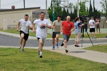 Wolf Pack leadership leads the first run for the Wolf Pack Warrior Mud Run at Kunsan Air Base, Republic of Korea, June 8, 2013. The course was 1.88 miles long with obstacles to test participants’ physical and mental abilities scattered along the way. (U.S. Air Force photo by Senior Airman Clayton Lenhardt/Released)