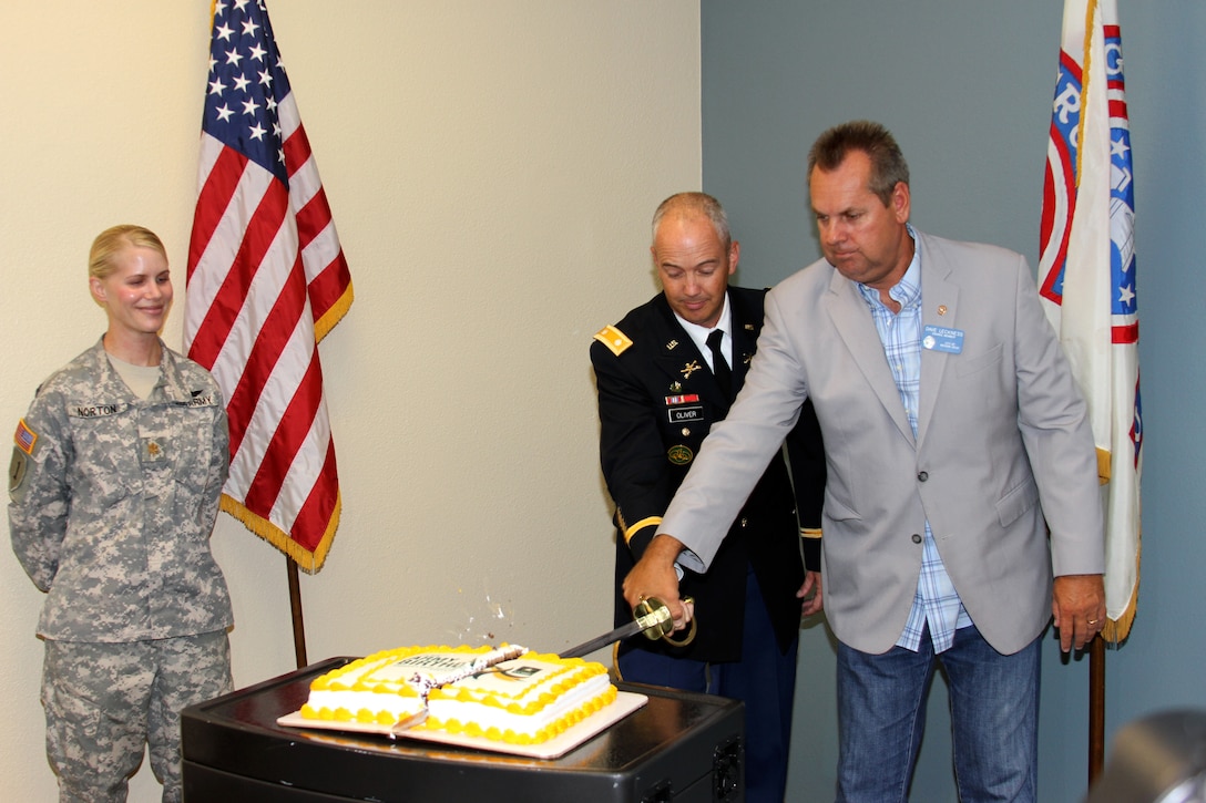 Lt. Col. John A. Oliver Jr., commander of the U.S. Army's Southern California Recruiting Battalion, and David Leckness, a city councilman from Mission Viejo, Calif., cut a birthday cake commemorating the Army's 238th birthday during the openin