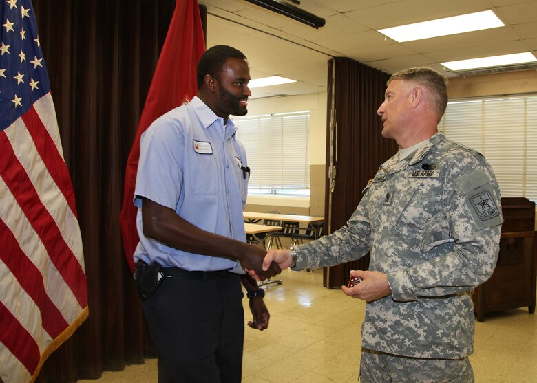 (l to r) Daaniyal Mcgill, Distribution and Electrical Section, Maintenance Branch, receives a coin for his outstanding service from Sgt. Maj. of the Army Raymond F. Chandler III. Chandler visited the Washington Aqueduct to learn more about the Corps unique and diverse mission, June 5.