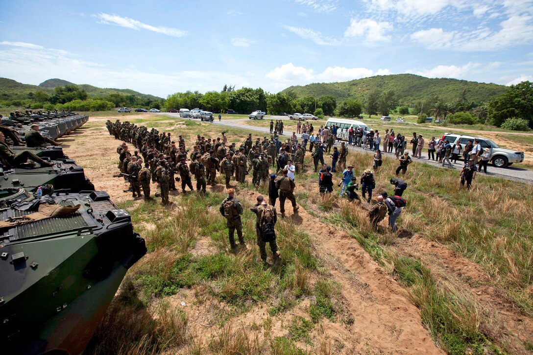 U.S. Marines and sailors meet with Thai marines after an amphibious raid exercise during Cooperation Afloat Readiness and Training 2013 at Camp Samae San near Sattahip, Thailand, June 10, 2013.