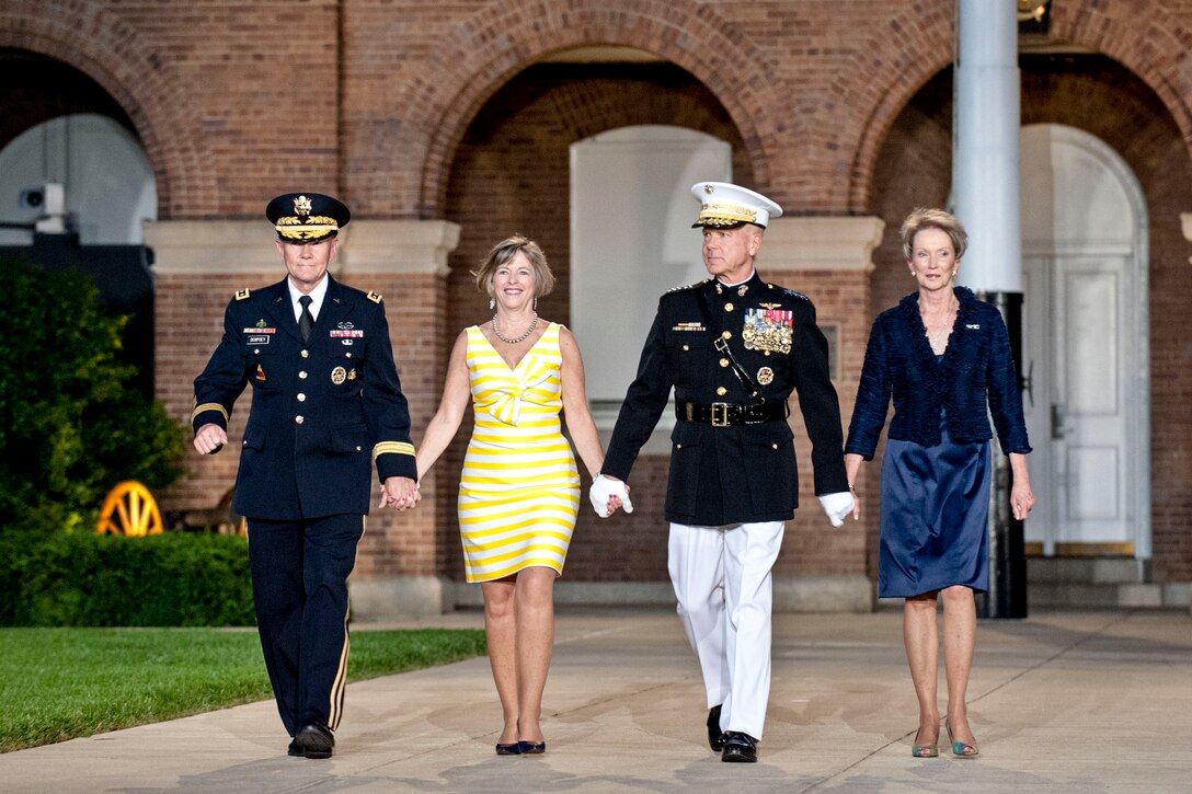 From left, Army Gen. Martin E. Dempsey, chairman of the Joint Chiefs of Staff, his wife, Deanie, Marine Corps Commandant Gen. James F. Amos and his wife, Bonnie, arrive for an evening parade at the Marine Barracks in Washington, D.C., June 14, 2013.