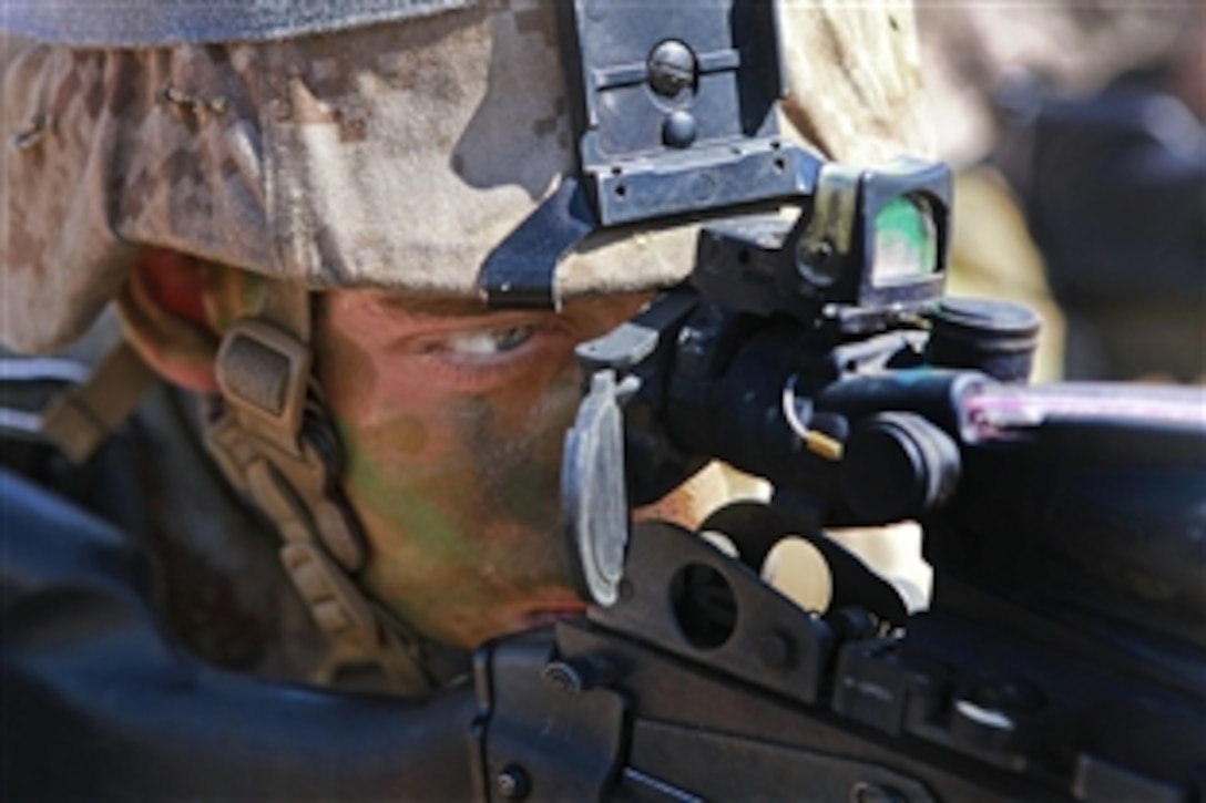 A Marine provides security from a trench during an exercise at the Mount Bundey Training Area, Australia, June 13, 2013. The Marine is assigned to Lima Company, 3rd Battalion, 3rd Marine Regiment, Marine Rotational Force Darwin. Marines from that unit and their Australian counterparts trained together in the field for two weeks.