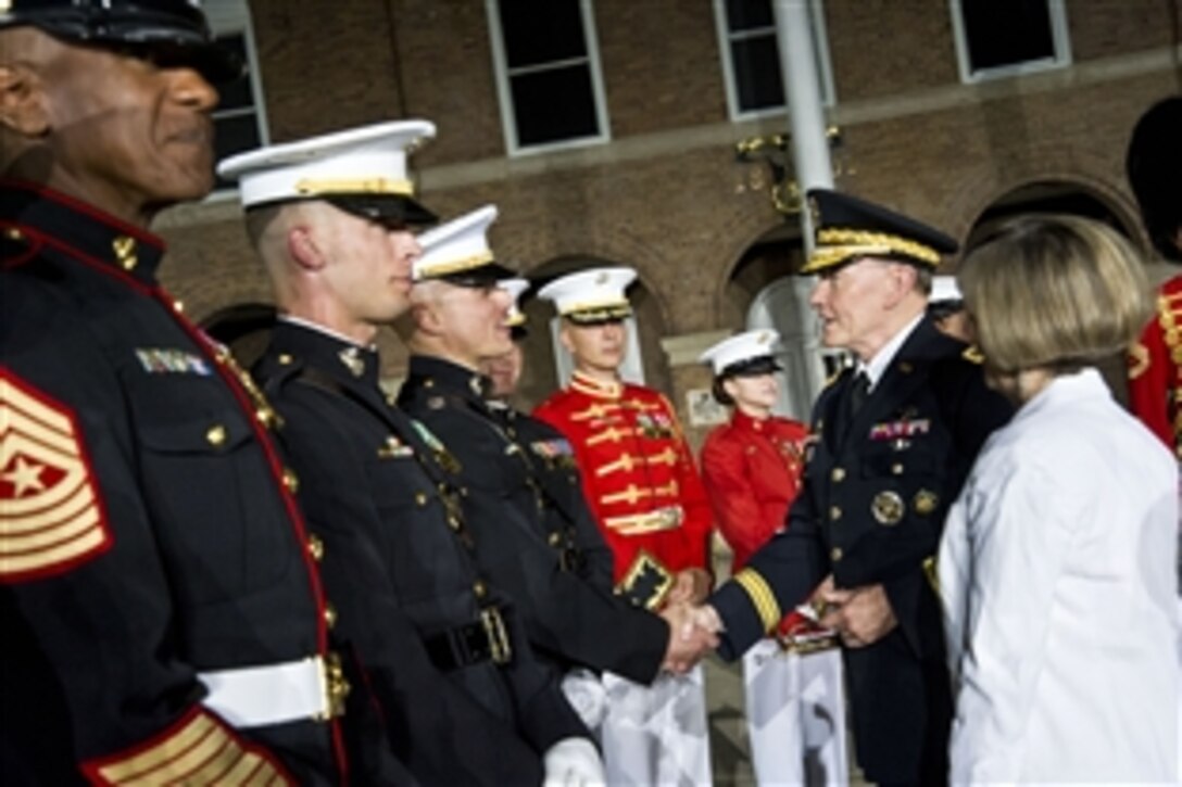 Army Gen. Martin E. Dempsey, chairman of the Joint Chiefs of Staff, and his wife, Deanie, greet Marines during an evening parade at the Marine Corps Barracks in Washington, D.C., June 14, 2013. 