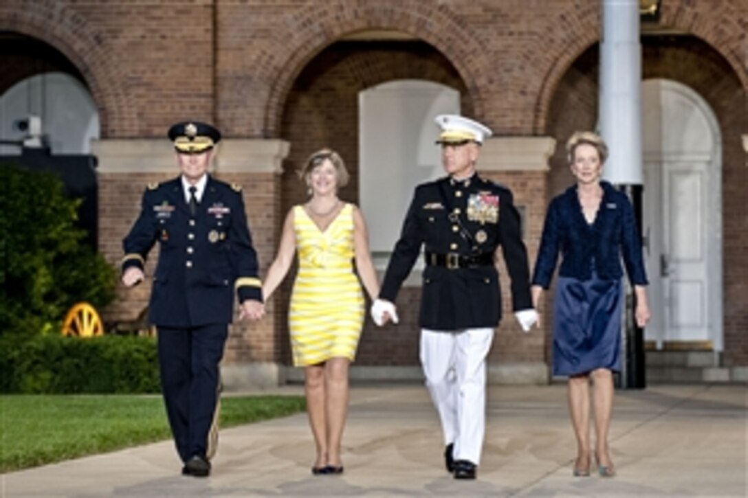From left, Army Gen. Martin E. Dempsey, chairman of the Joint Chiefs of Staff; his wife, Deanie; Marine Corps Commandant Gen. James F. Amos; and his wife, Bonnie, arrive during an evening parade at the Marine Corps Barracks in Washington, D.C., June 14, 2013.