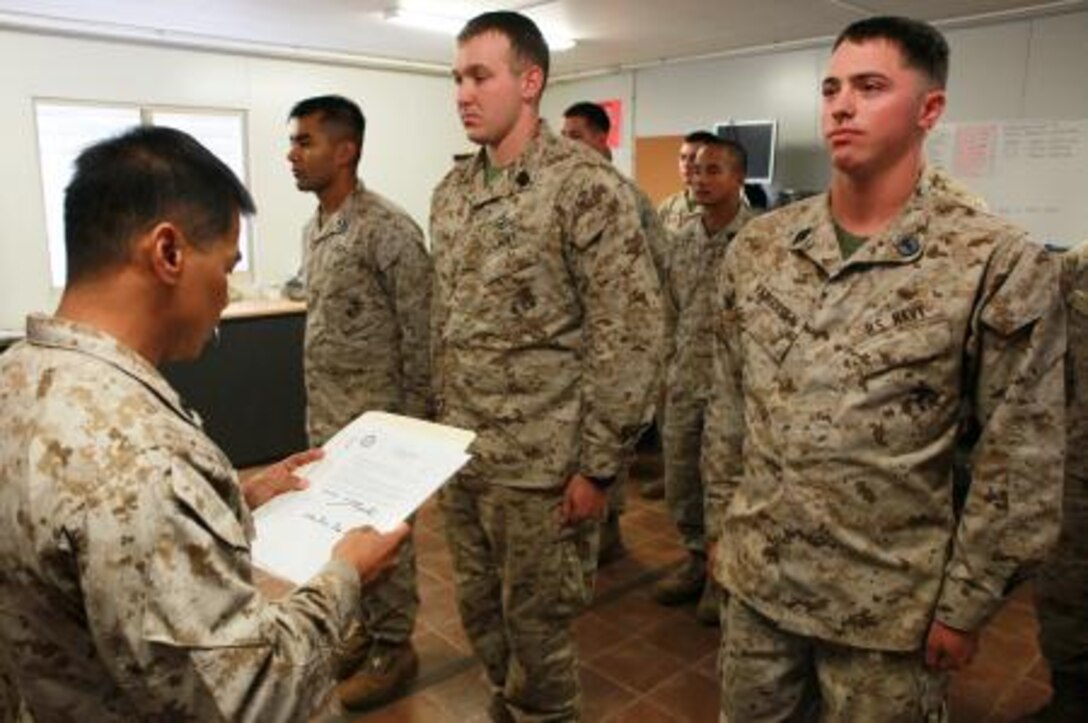 (From left to right) Chief Petty Officer Eduardo Magpayo, senior medical representative, Lima Company, 3rd Battalion, 3rd Marine Regiment, Marine Rotational Force – Darwin, reads aloud the promotion citations of Petty Officer 3rd Class Michael Morales, Petty Officer 3rd Class Nathan Hatton, both promoted to petty officer second class, and Seaman Ryan Van Gorden, promoted to petty officer third class, all corpsman with Lima Co., 3rd Bn., 3rd Marine Regiment, MRF-D, during a promotion formation and a US Navy Hospital Corps birthday celebration, here, June 17. This birthday marks 115 years of the US Navy Hospital Corps.
