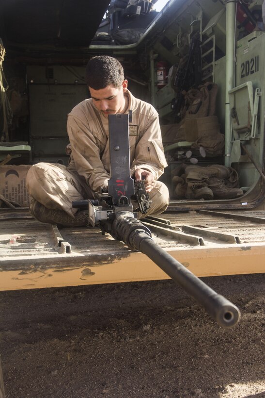 Pfc. Daniel Berard, amphibious assault vehicle (AAV) crewman from Jackson, Tenn. of AAV Platoon, Battalion Landing Team 3/2, 26th Marine Expeditionary Unit (MEU), function checks a .50-caliber heavy machine gun before a live-fire range with the Jordanian Army as part of Exercise Eager Lion 2013 in Al Quweira, Jordan, June 10, 2013. Exercise Eager Lion 2013 is an annual, multinational exercise designed to strengthen military-to-military relationships and enhance security and stability in the region by responding to realistic, modern-day security scenarios. The 26th MEU is a Marine Air-Ground Task Force forward-deployed to the U.S. 5th Fleet area of responsibility aboard the Kearsarge Amphibious Ready Group serving as a sea-based, expeditionary crisis response force capable of conducting amphibious operations across the full range of military operations. (U.S. Marine Corps photo by Cpl. Michael S. Lockett/Released)