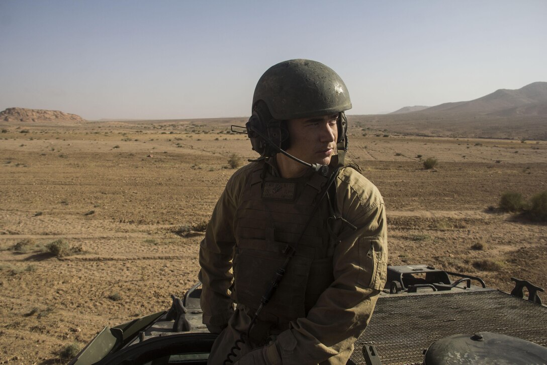 Lance Cpl. Matthew Flippo, amphibious assault vehicle (AAV) crewman from Amory, Miss., assigned to AAV Platoon, Battalion Landing Team 3/2, 26th Marine Expeditionary Unit (MEU), rides out to a live-fire range during Exercise Eager Lion 2013 in Al Quweira, Jordan, June10, 2013. Exercise Eager Lion 2013 is an annual, multinational exercise designed to strengthen military-to-military relationships and enhance security and stability in the region by responding to realistic, modern-day security scenarios. The 26th MEU is a Marine Air-Ground Task Force forward-deployed to the U.S. 5th Fleet area of responsibility aboard the Kearsarge Amphibious Ready Group serving as a sea-based, expeditionary crisis response force capable of conducting amphibious operations across the full range of military operations. (U.S. Marine Corps photo by Cpl. Michael S. Lockett/Released)