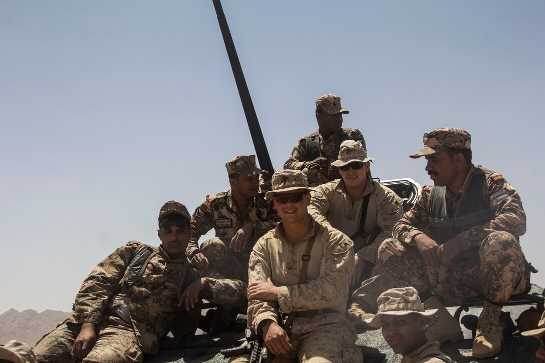 U.S. Marines of Battalion Landing Team 3/2, 26th Marine Expeditionary Unit (MEU), talk to Jordanian soldiers during Exercise Eager Lion 2013 in Al Quweira, Jordan, June10, 2013. Exercise Eager Lion 2013 is an annual, multinational exercise designed to strengthen military-to-military relationships and enhance security and stability in the region by responding to realistic, modern-day security scenarios. The 26th MEU is a Marine Air-Ground Task Force forward-deployed to the U.S. 5th Fleet area of responsibility aboard the Kearsarge Amphibious Ready Group serving as a sea-based, expeditionary crisis response force capable of conducting amphibious operations across the full range of military operations. (U.S. Marine Corps photo by Cpl. Michael S. Lockett/Released)