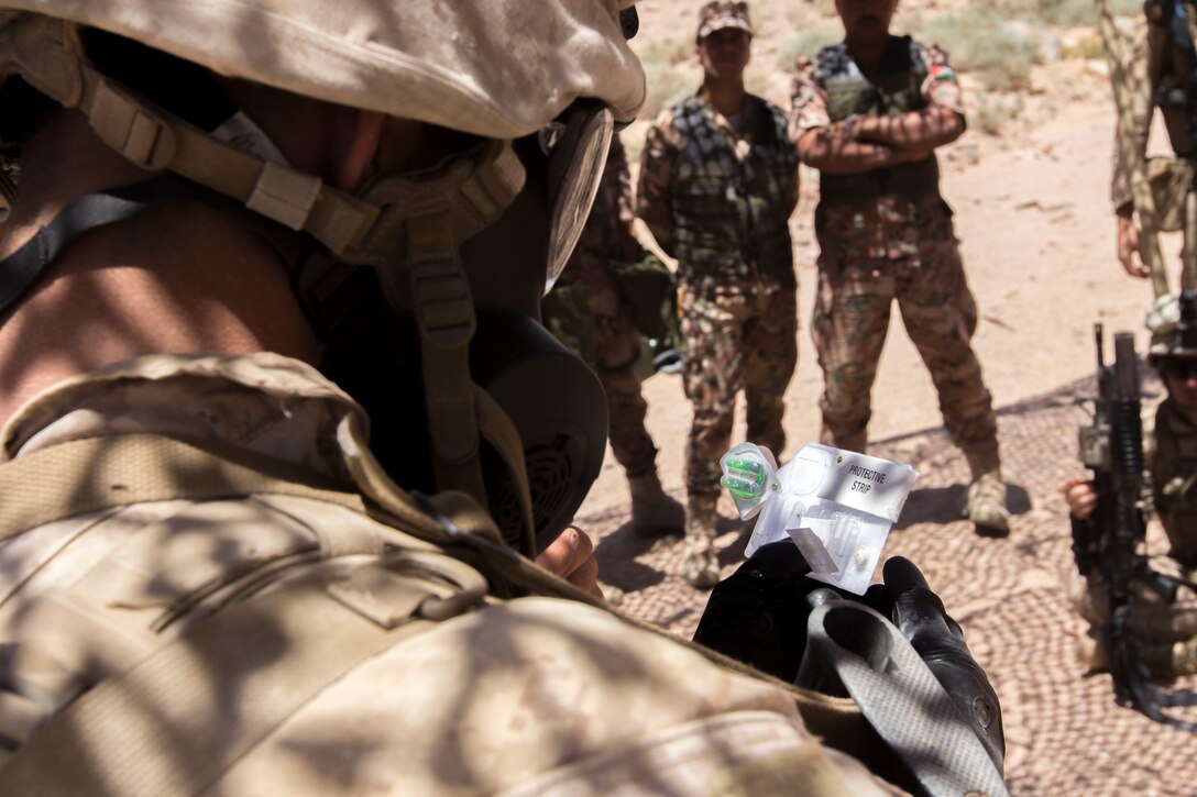 U.S. Marine Corps Lance Cpl. James Chapman, a Clemson, S.C., native and rifleman assigned to Company K, Battalion Landing Team 3/2, 26th Marine Expeditionary Unit (MEU), conducts chemical, biological, radiological and nuclear bilateral familiarization training with the Jordanian Armed Forces during Exercise Eager Lion 2013 in Al Quweira, Jordan, June 15, 2013. Exercise Eager Lion 2013 is an annual multinational exercise designed to strengthen military-to-military relationships and enhance security and stability in the region. The 26th MEU is a Marine Air-Ground Task Force forward-deployed to the U.S. 5th Fleet area of responsibility aboard the Kearsarge Amphibious Ready Group serving as a sea-based, expeditionary crisis response force capable of conducting amphibious operations across the full range of military operations. (U.S. Marine Corps photo by Cpl. Kyle N. Runnels/Released)