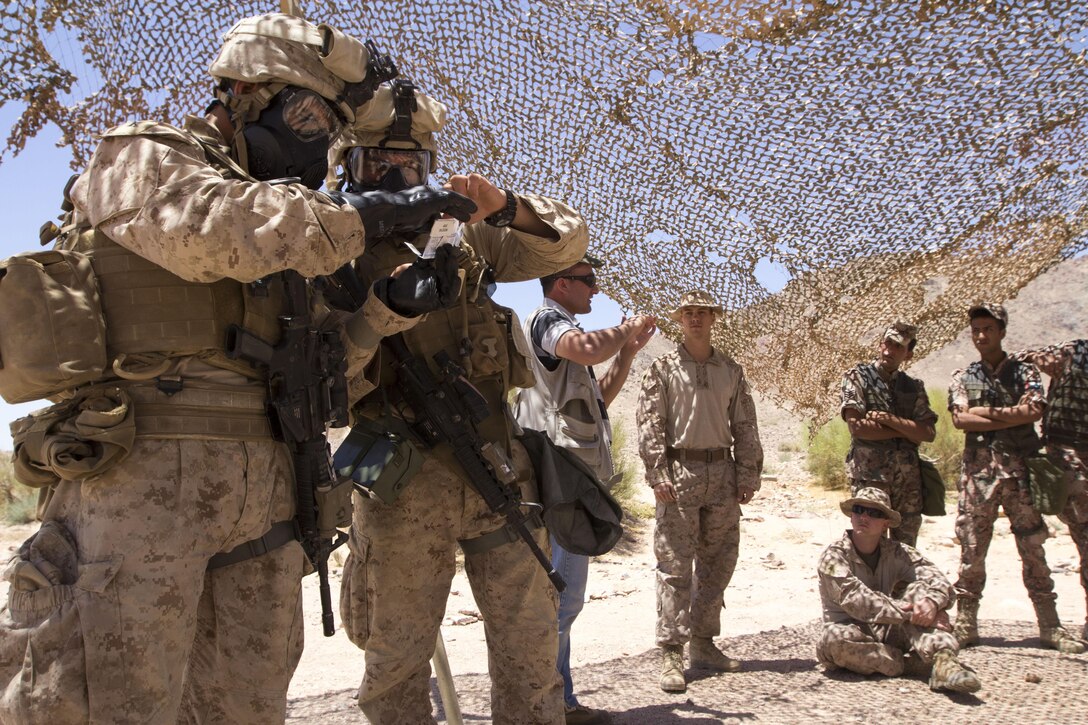 U.S. Marines assigned to Company K, Battalion Landing Team 3/2, 26th Marine Expeditionary Unit (MEU), conduct chemical, biological, radiological and nuclear bilateral familiarization training with the Jordanian Armed Forces during Exercise Eager Lion 2013 in Al Quweira, Jordan, June 15, 2013. Exercise Eager Lion 2013 is an annual multinational exercise designed to strengthen military-to-military relationships and enhance security and stability in the region. The 26th MEU is a Marine Air-Ground Task Force forward-deployed to the U.S. 5th Fleet area of responsibility aboard the Kearsarge Amphibious Ready Group serving as a sea-based, expeditionary crisis response force capable of conducting amphibious operations across the full range of military operations. (U.S. Marine Corps photo by Cpl. Kyle N. Runnels/Released)