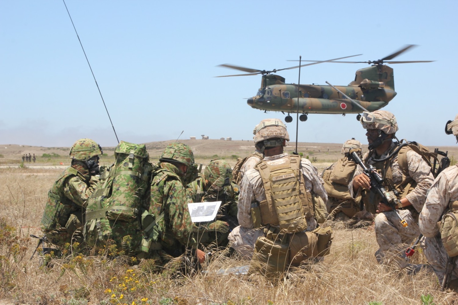 U.S. Marines from the 13th Marine Expeditionary Unit and Japanese Self-Defense Force soldiers go over maneuver tactics while conducting amphibious assault operations on San Clemente Island June 17, 2013.