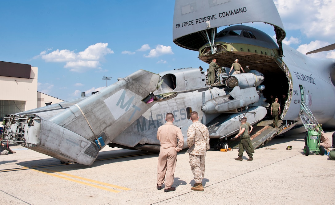 JOINT BASE MCGUIRE-DIX LAKEHURST, N.J.—Marines from Marine Heavy Helicopter Squadron (HMH) 772 load a CH-53E Super Stallion onto a C-5 Galaxy May 30, 2013, at Joint Base McGuire-Dix-Lakehurst, N.J. Nearly half of HMH-772 departed the joint base May 30-31, 2013, for a six-month deployment to Marine Corps Air Station Futenma, Japan. The C-5 and its crew are assigned to the 433rd Airlift Wing at Joint Base San Antonio, Texas. 