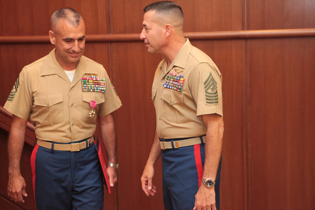 Sgt. Maj. James E. Booker, former Marine Forces Reserve and Marine Forces North sergeant major, (left) has a few final words with his replacement, incoming sergeant major, 3rd Marine Aircraft Wing Sergeant Major, Sgt. Maj. Anthony A. Spadaro, after the conclusion of Booker’s relief and farewell ceremony, in which he  relinquished his post and bid farewell to the unit prior to departing to his next command.  Booker will be taking the position of North Atlantic Treaty Organization, International Security Assistance Force and United States Forces-Afghanistan senior enlisted advisor for Gen. Joseph F. Dunford, commander of the NATO ISAF and USFORAF. (Official U.S. Marine Corps photo by Cpl. Fenton Reese) 