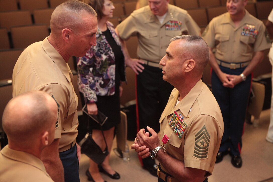 Sgt. Maj. James E. Booker, former Marine Forces Reserve and Marine Force North sergeant major, (right) speaks with a peer, after the conclusion of his relief and farewell ceremony, in which he relinquished his post and bid farewell to the unit prior to departing to his next command.  Booker will be taking the position of North Atlantic Treaty Organization, International Security Assistance Force and United States Forces-Afghanistan senior enlisted advisor for Gen. Joseph F. Dunford, commander of the NATO ISAF and USFORAF. (Official U.S. Marine Corps photo by Cpl. Fenton Reese) 