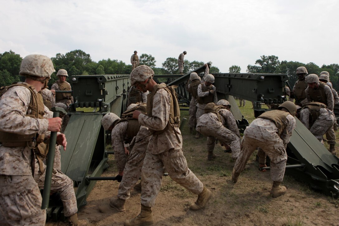 BATTLE CREEK, Mich. – Marines with 6th Engineer Support Battalion assemble a medium girder bridge during a training exercise here, June 11. Marines participated in a two-week training exercise that covered basic combat engineer capabilities such as: demolition, construction and bridging. 