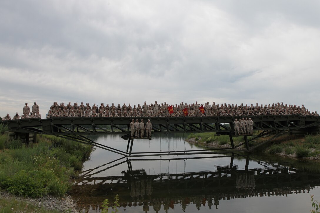 BATTLE CREEK, Mich. – Marines with Bridge Companies A, B and C, 6th Engineer Support Battalion pose atop a medium girder bridge during a training exercise here, June 11. These Marines worked together late into the night in order to complete the project in a single day. 