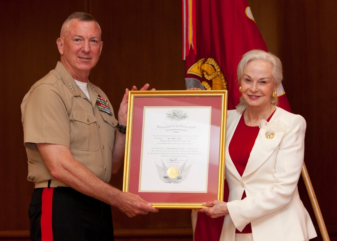NEW ORLEANS -- Lt. Gen. Steven A. Hummer, commander of Marine Forces Reserve and Marine Forces North, awards the Honorary Marine certificate to Phyllis M. Taylor, chairman of the Patrick F. Taylor Foundation, during the Honorary Marine Ceremony held at Marine Corps Support Facility New Orleans, June 14. The Honorary Marine title is designated to reinforce the special bond between the American people and the Corps by recognizing individuals in the community who have made extraordinary contributions to the Marine Corps. It can only be awarded by the commandant of the Marine Corps. Taylor is the 76th recipient since the first award in 1992. (U.S. Marine Corps photo by Lance Cpl Mackenzie Schlueter)