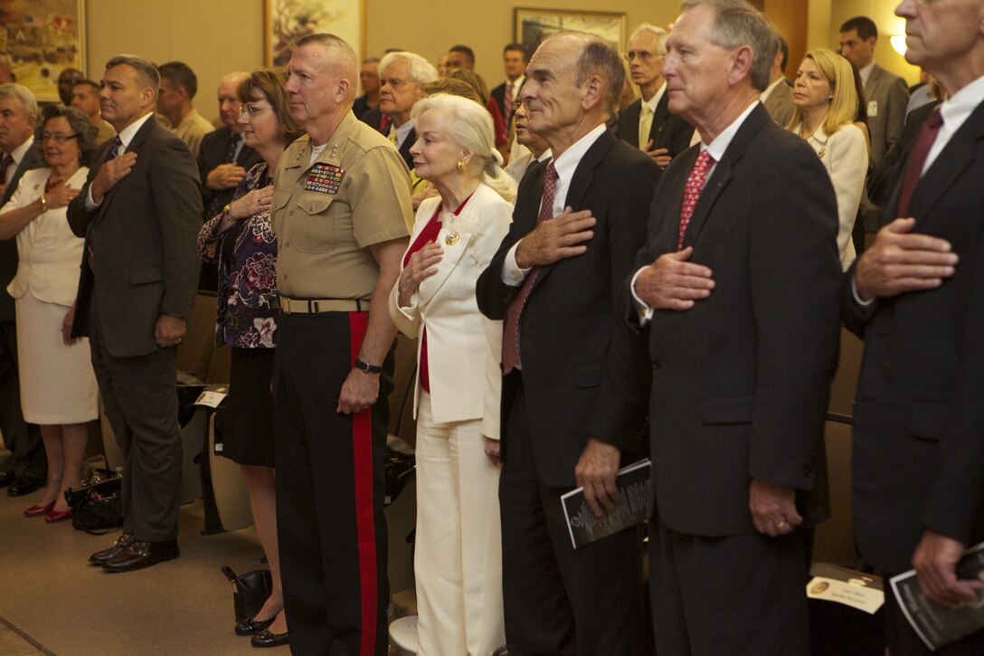 NEW ORLEANS -- Phyllis M. Taylor, philanthropist, life-long Marine Corps supporter and wife of the late veteran and entrepreneur Patrick F. Taylor, stands alongside Lt. Gen. Steven A. Hummer, commander of Marine Forces Reserve, as they render honors during the playing of the national anthem at the “Honorary Marine” ceremony, at the Marine Corps Support Facility New Orleans, in which Taylor became the 76th Honorary Marine, June 14. (Official Marine Corps photo by Cpl. Fenton Reese)