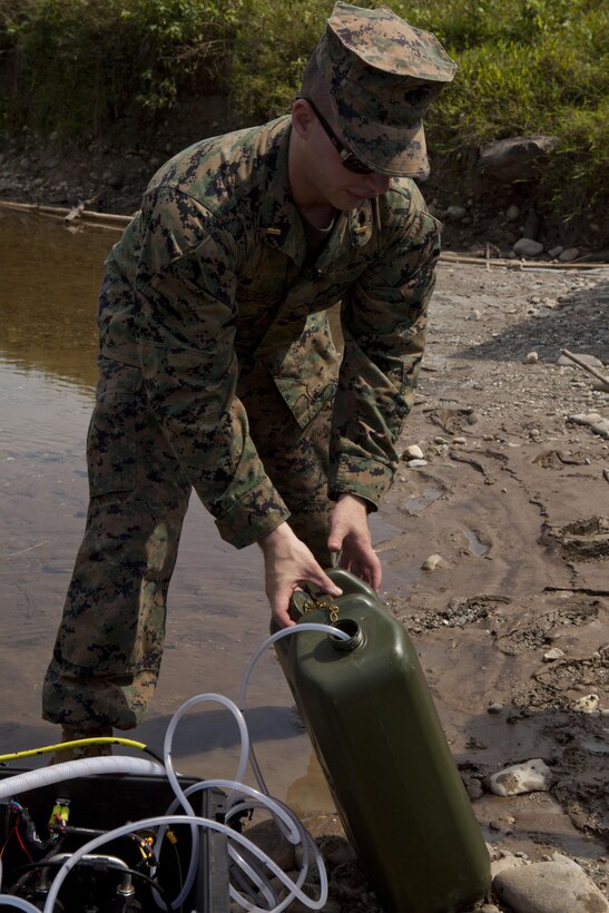 U.S. Marine 2nd Lt. Michael Wisotzkey, a combat engineer officer with III Marine Expeditionary Force, fills a five-gallon jug with purified water from the Solar Hybrid Expeditionary Power and Purification System as part of a disaster-response scenario during the ASEAN Humanitarian Assistance/Disaster Relief and Military Medicine Exercise hosted by Brunei Darussalam June 17 in Temburong, Brunei. More than 2,500 multinational personnel from 18 Asia-Pacific nations are participating in the ASEAN exercise, which provides a platform for regional partner nations to address shared security challenges, strengthen defense cooperation, enhance interoperability and promote stability in the region. The exercise is scheduled from June 17 to 20.