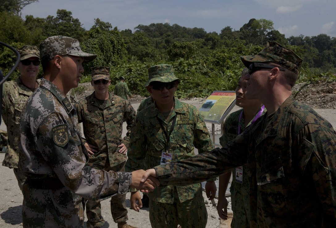 Engineers from China, Singapore and the U.S. greet one another before working together to purify water utilizing the Solar Hybrid Expeditionary Power and Purification Systems as part of a disaster-response scenario during the ASEAN Humanitarian Assistance/Disaster Relief and Military Medicine Exercise hosted by Brunei Darussalam June 17 in Temburong, Brunei. The ASEAN exercise marks the first time multinational forces will conduct a field training exercise under the ASEAN Defence Ministers Meeting-Plus architecture and is a milestone event for regional cooperation. More than 2,500 multinational personnel from 18 Asia-Pacific nations are participating in the ASEAN exercise from June 17 to 20.