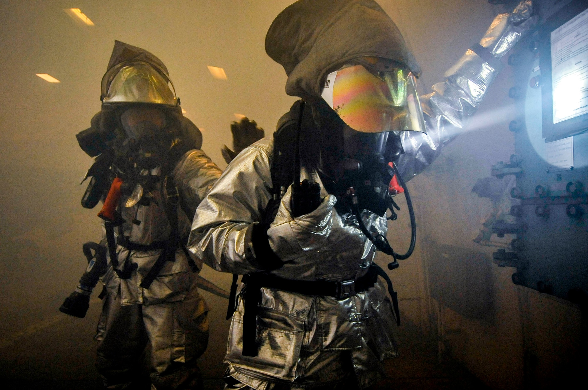 Firefighters from the 35th Civil Engineer Squadron cleared smoke from a Hardened Aircraft Shelter by opening the main doors during an Operational Readiness Exercise at Misawa Air Base, Japan, June 18, 2013. A four-man team put out a simulated fire and rescued an unconscious pilot from a smoke filled cockpit. (U.S. Air Force photo by Staff Sgt. Nathan Lipscomb)