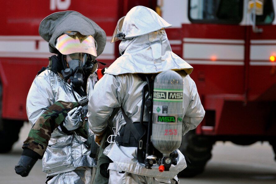 Firefighters from the 35th Civil Engineer Squadron carry a simulated pilot away from a pilot egress training scenario during an Operational Readiness Exercise at Misawa Air Base, Japan, June 18, 2013. The scenario simulated smoke in the cockpit and an unconscious pilot. A four-man crew made entry into a Hardened Aircraft Shelter to remove the pilot from his aircraft. (U.S. Air Force photo by Airman 1st Class Zachary Kee)