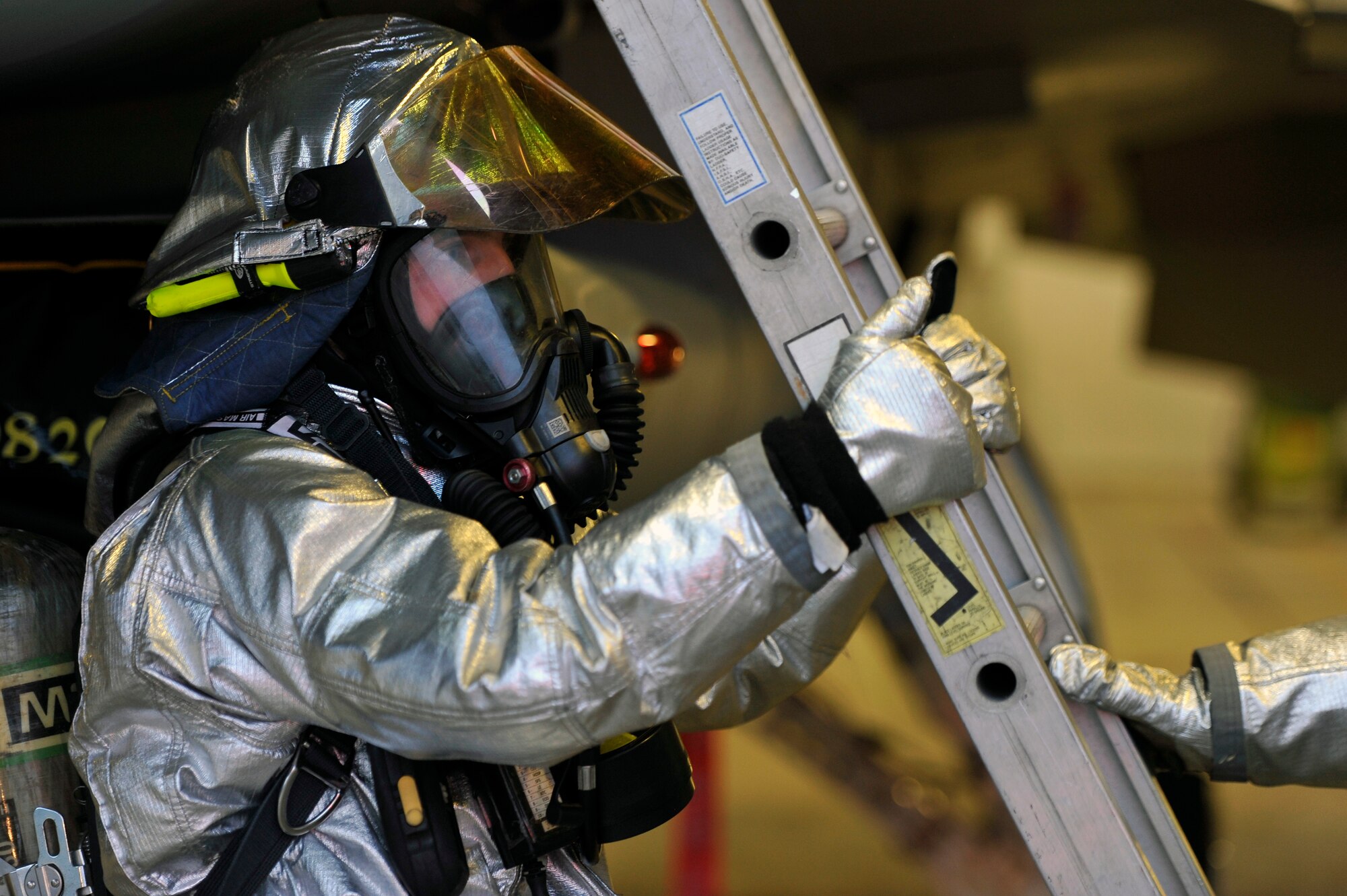 U.S. Air Force Senior Airman Justin Najarian, 35th Civil Engineer Squadron firefighter, puts a ladder in place during a simulated pilot egress training scenario at Misawa Air Base, Japan, June 18, 2013. This scenario allows 35 CES firefighters to safely rescue a pilot who is unable to get out of the cockpit due to unconsciousness or other obstacles. (U.S. Air Force photo by Airman 1st Class Zachary Kee)