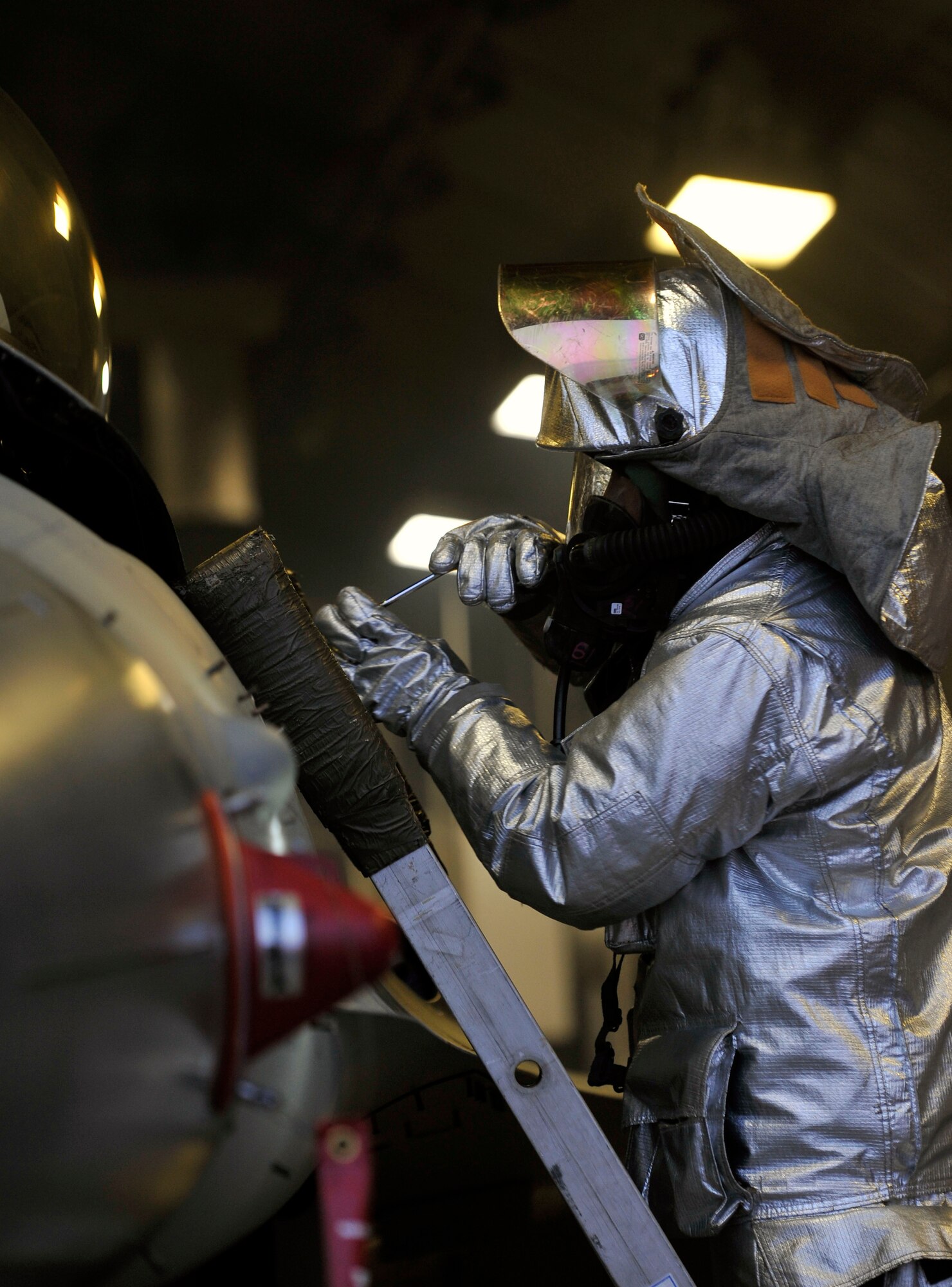 U.S. Air Force Staff Sgt. Jason Kawaguchi, 35th Civil Engineer Squadron firefighter, uses tools to force open the canopy of an F-16 Fighting Falcon aircraft during a simulated pilot egress training scenario at Misawa Air Base, Japan, June 18, 2013. This training was part of a weeklong Operational Readiness Exercise that prepared Airmen for contingency operations and wartime scenarios. (U.S. Air Force photo by Airman 1st Class Zachary Kee)