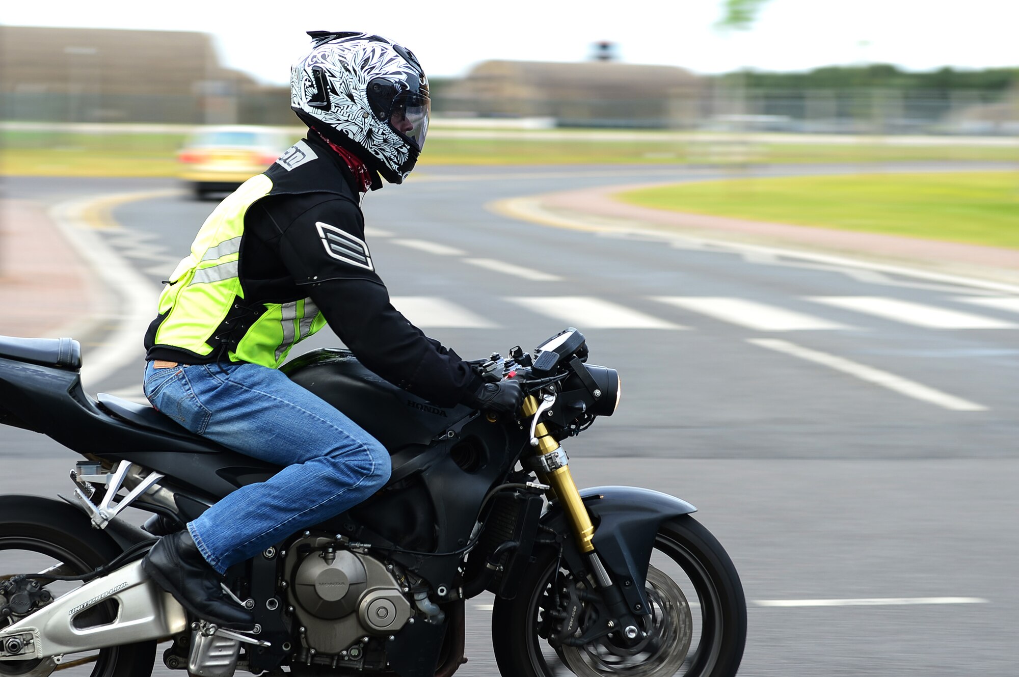 ROYAL AIR FORCE LAKENHEATH - Senior Airman Nikolas Kinder, 48th Equipment Maintenance Squadron phase inspection journeyman, rides his motorcycle June 17, 2013. Airmen who ride motorcycles are required to wear an approved helmet; a long-sleeved shirt or jacket that is brightly colored, visible and reflective at night; long pants; full-fingered gloves; sturdy footwear and eye protection including prescription glasses. For members in England, helmets must meet United Nations Economic Commission for Europe Standard 22.05 or British Standard 6658 and be properly fastened under the chin. (U.S. Air Force photo by Senior Airman Lausanne Morgan)