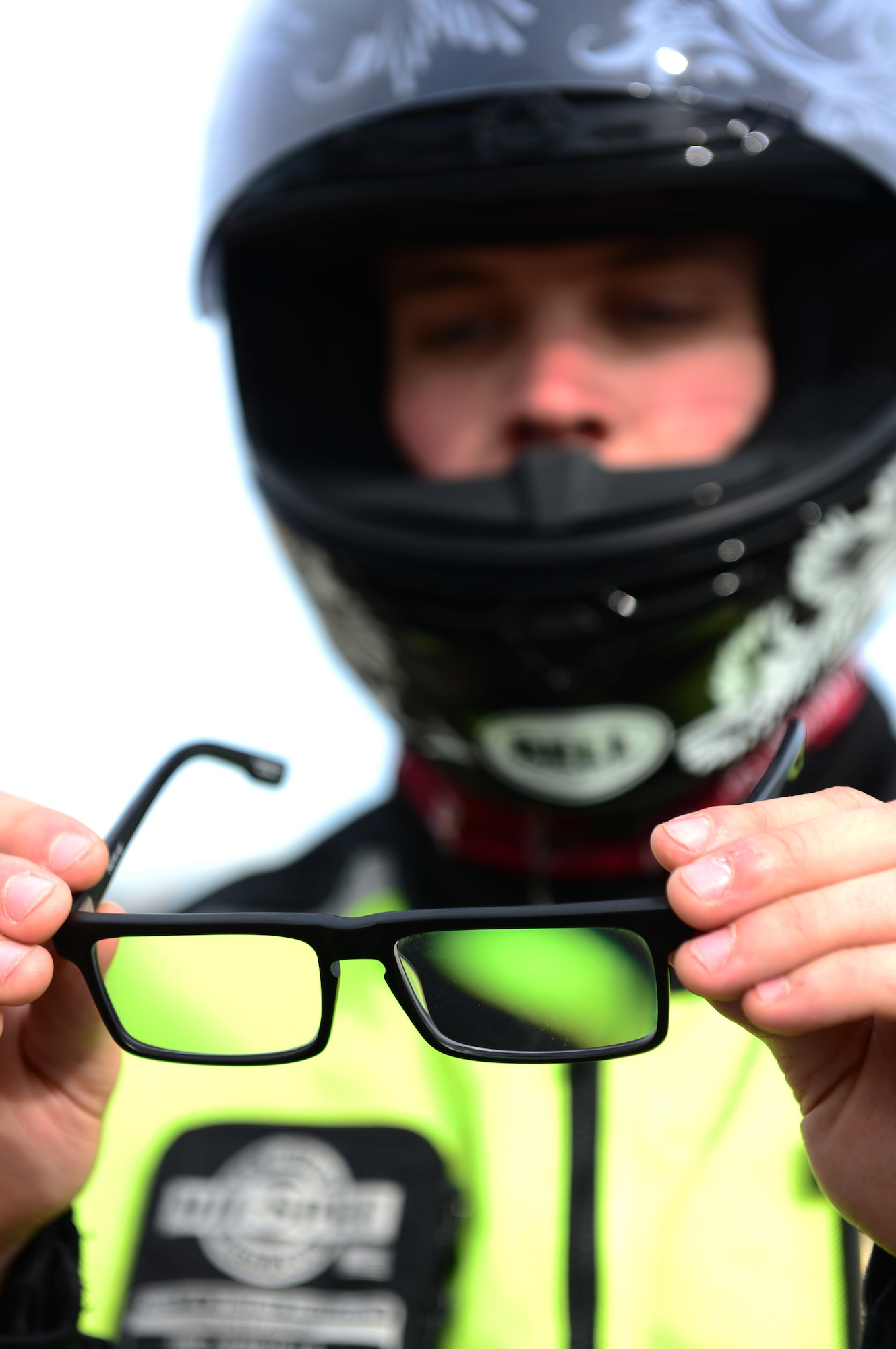 ROYAL AIR FORCE LAKENHEATH - Senior Airman Nikolas Kinder, 48th Equipment Maintenance Squadron phase inspection journeyman, prepares to put on glasses prior to riding his motorcycle June 17, 2013. Airmen who ride motorcycles are required to wear an approved helmet; a long-sleeved shirt or jacket that is brightly colored, visible and reflective at night; long pants; full-fingered gloves; sturdy footwear and eye protection including prescription glasses. For members in England, helmets must meet United Nations Economic Commission for Europe Standard 22.05 or British Standard 6658 and be properly fastened under the chin. (U.S. Air Force photo by Senior Airman Lausanne Morgan)