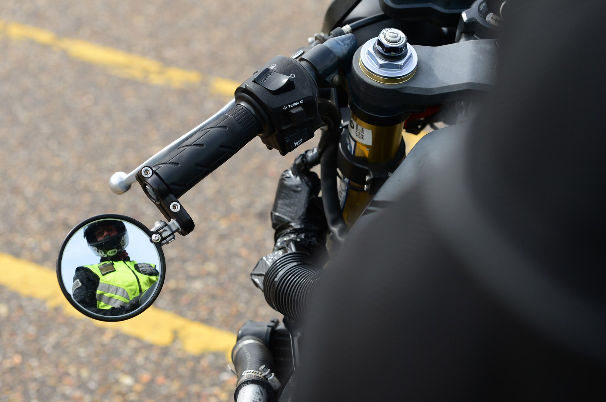 ROYAL AIR FORCE LAKENHEATH - Senior Airman Nikolas Kinder, 48th Equipment Maintenance Squadron phase inspection journeyman, performs checks on his motorcycle prior to riding June 17, 2013. Airmen who ride motorcycles are required to wear an approved helmet; a long-sleeved shirt or jacket that is brightly colored, visible and reflective at night; long pants; full-fingered gloves; sturdy footwear and eye protection including prescription glasses. For members in England, helmets must meet United Nations Economic Commission for Europe Standard 22.05 or British Standard 6658 and be properly fastened under the chin. (U.S. Air Force photo by Senior Airman Lausanne Morgan)