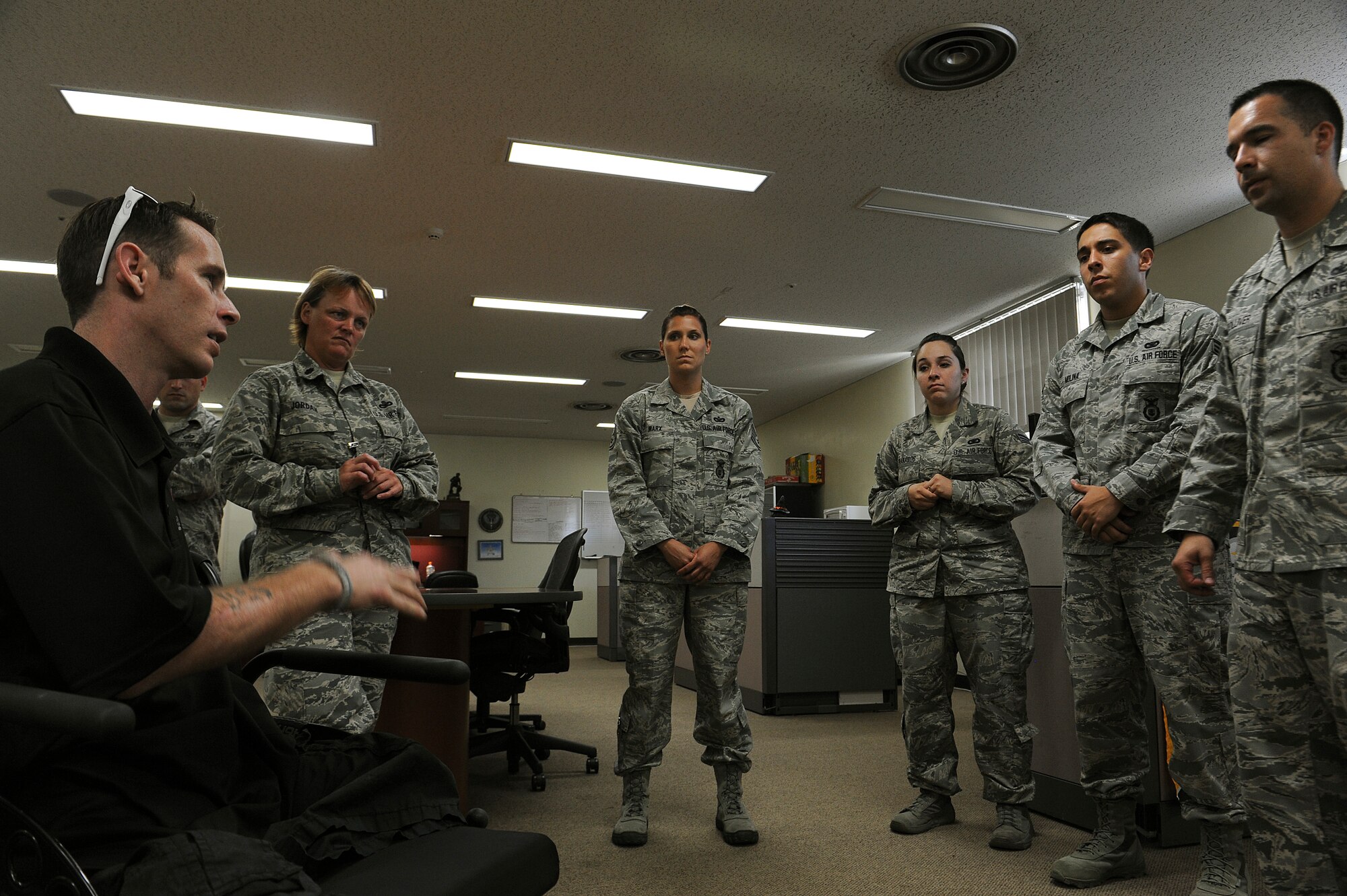 Bryan Anderson, U.S. Army veteran and triple amputee, talks with members from the 18th Security Forces Squadron on Kadena Air Base, Japan, June 17, 2013. Anderson was a military policeman in the Army and was able to see how U.S. Air Force security forces members conduct their mission within the different sections of their squadron. (U.S. Air Force photo by Airman 1st Class Malia Jenkins/Released)