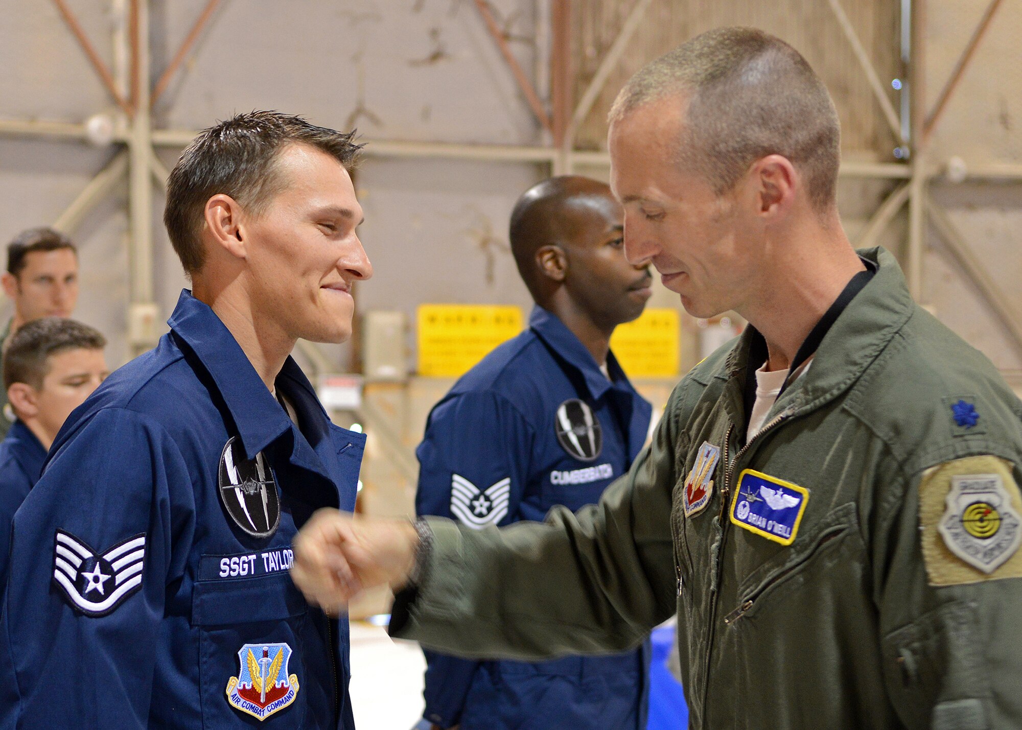 Lt. Col. Brian O’Neill, 31st Test and Evaluation Squadron commander, presents Staff Sgt. Trevor Taylor, 31st TES dedicated crew chief, with a specially-designed, tail number patch and squadron patch during a dedicated crew chief ceremony June 14. The ceremony marked a milestone that coincided with the squadron’s recent acquisition of its first F-35 Lightning II aircraft specifically assigned for operational test and evaluation. (U.S. Air Force photo by Jet Fabara)