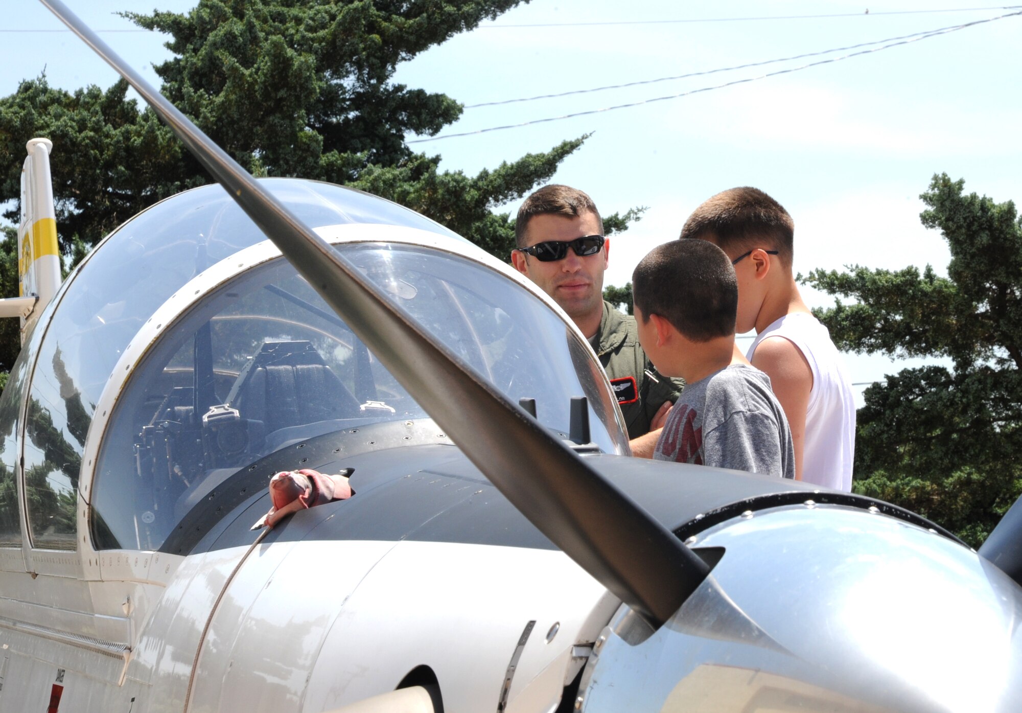 1st Lt. Trey Taylor, an instructor pilot with the 33rd Flying Training Squadron, explains the ins and outs of a T-6 Texan II to campers on a tour of the base during Camp Tomahawk, held June 3-14 at Vance Air Force Base, Okla. (U.S. Air Force photo/ Senior Airman Frank Casciotta)
