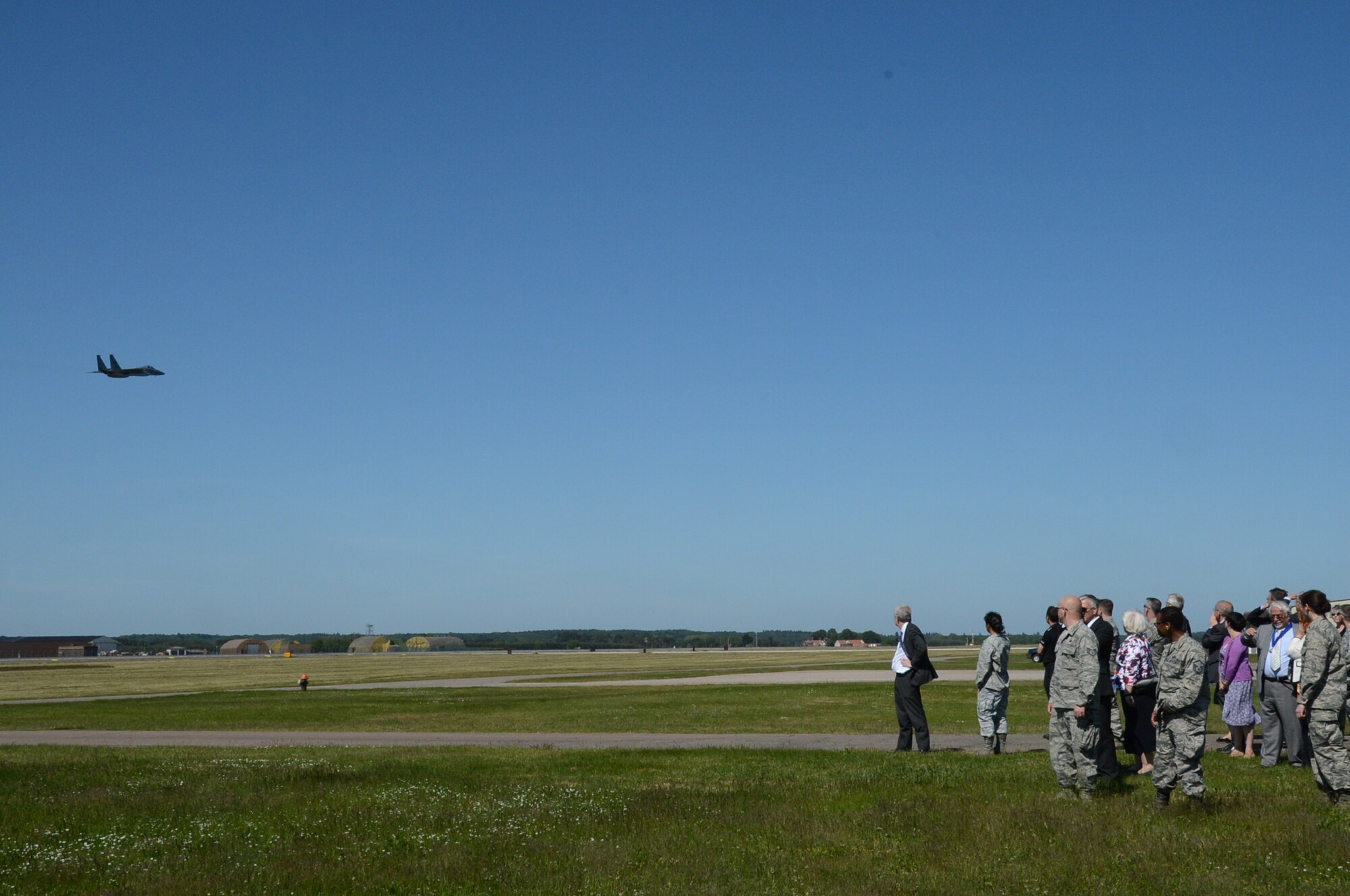 ROYAL AIR FORCE LAKENHEATH, England – Local community leaders and Liberty Wing Airmen observe an F-15C Eagle as it flies during the summer orientation June 7, 2013. The guests witnessed a birds of prey demonstration, F-15C Eagle take-offs and landings, a military working dog demonstration, and static displays during their visit. (U.S. Air Force photo by Trevor T. McBride)