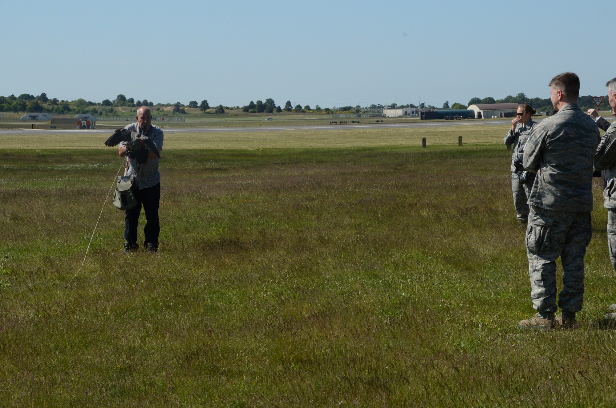ROYAL AIR FORCE LAKENHEATH, England – Keith Mutton, Phoenix Bird Control falconer, performs a birds of prey demonstration during the summer orientation June 7, 2013. The guests witnessed F-15C Eagle take-offs and landings, a military working dog demonstration, and static displays during their visit. (U.S. Air Force photo by Trevor T. McBride)
