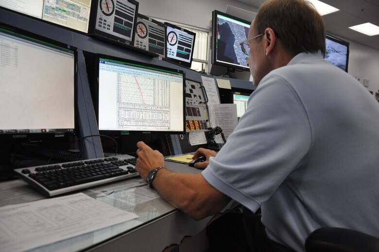 Jeremy Samuel, a range weather forecaster at the 45th Weather Squadron, monitors the weather June 18 at Cape Canaveral Air Force Station. Mr. Samuel and other members of the 45th Weather Squadron work around the clock to monitor and evaluate the weather in support of 45th Space Wing, 920th Rescue Wing and the Kennedy Space Center, helping to provide safety for employees and space assets. (U.S. Air Force Photo/Staff Sgt. Erin Smith)